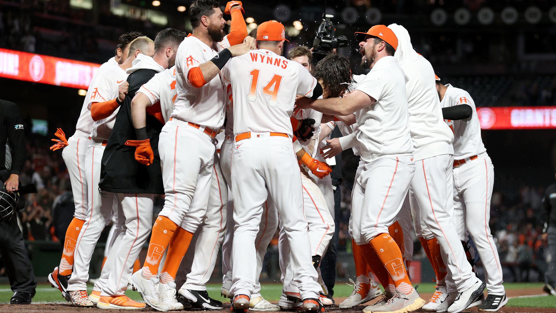 Giants teammates mob Brandon Crawford after he hit a walk-off home run in the bottom of the ninth against the D-backs on Aug. 14, 2022.