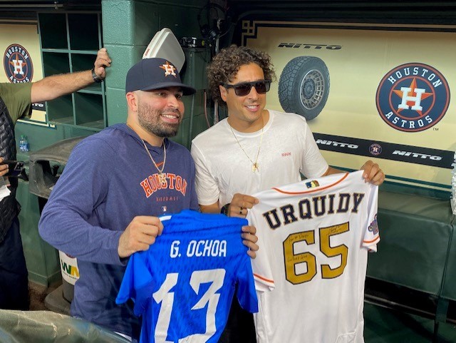 Astros player José Urquidy (left) stands with Mexican national team goalkeeper Guillermo Ochoa (right), posing for a photo while holding up each other's jersey after a jersey swap