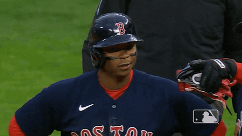 Red Sox third baseman Rafael Devers raises both his arms and waves his hands after getting a hit
