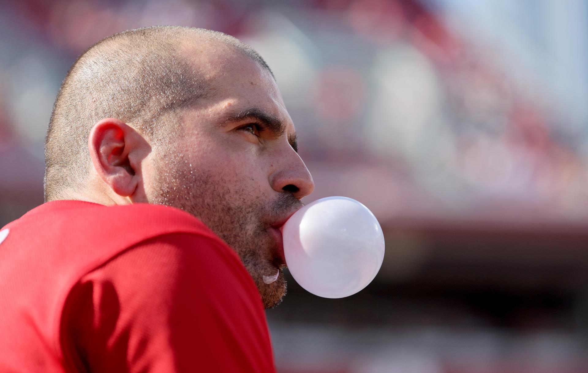 Side profile of Joey Votto blowing a bubble with his gum