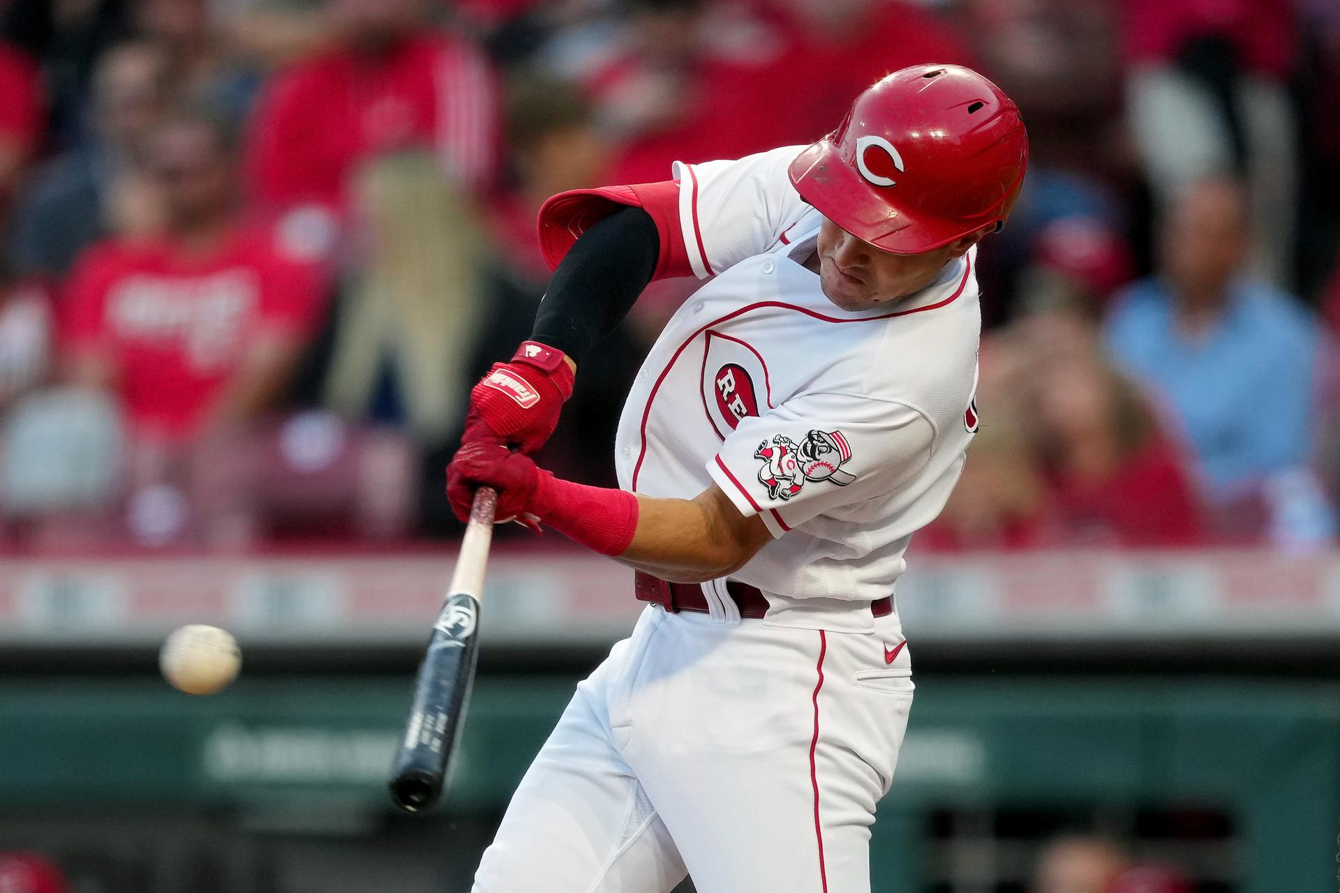 Reds player Alejo Lopez swings the bat and hits a single during a game