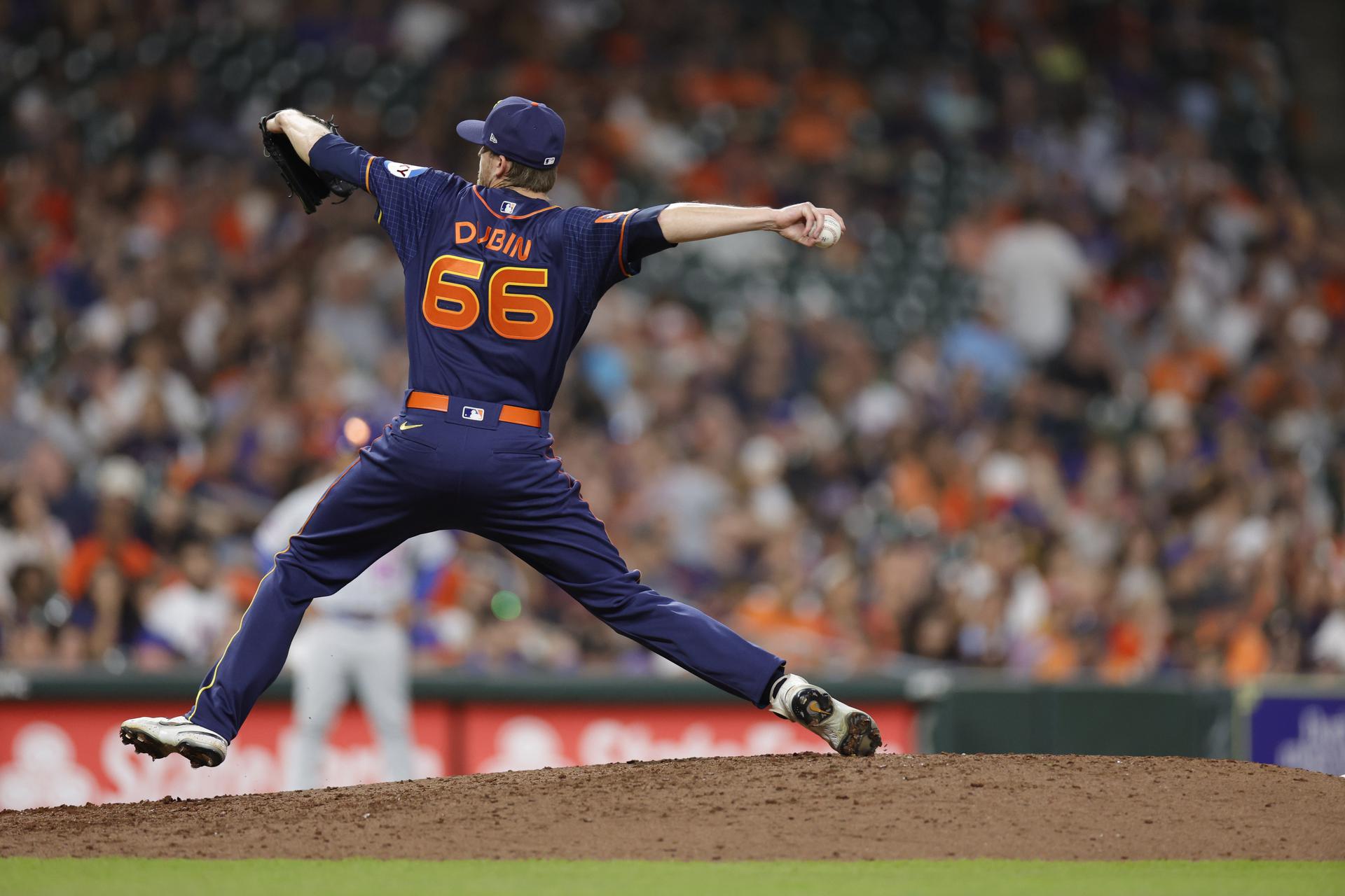 Back view of Shawn Dubin delivering a pitch in a game against the Mets