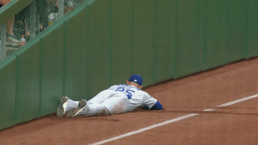 An animated GIF of Trayce Thompson holding up a ball after making a diving catch