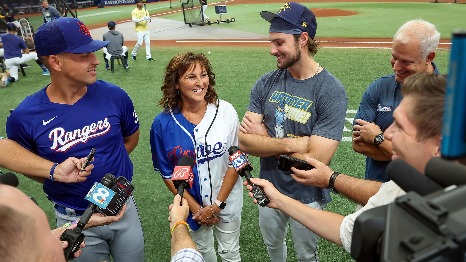 Nathaniel Lowe and Josh Lowe stand on the field with their mother, Wendy 