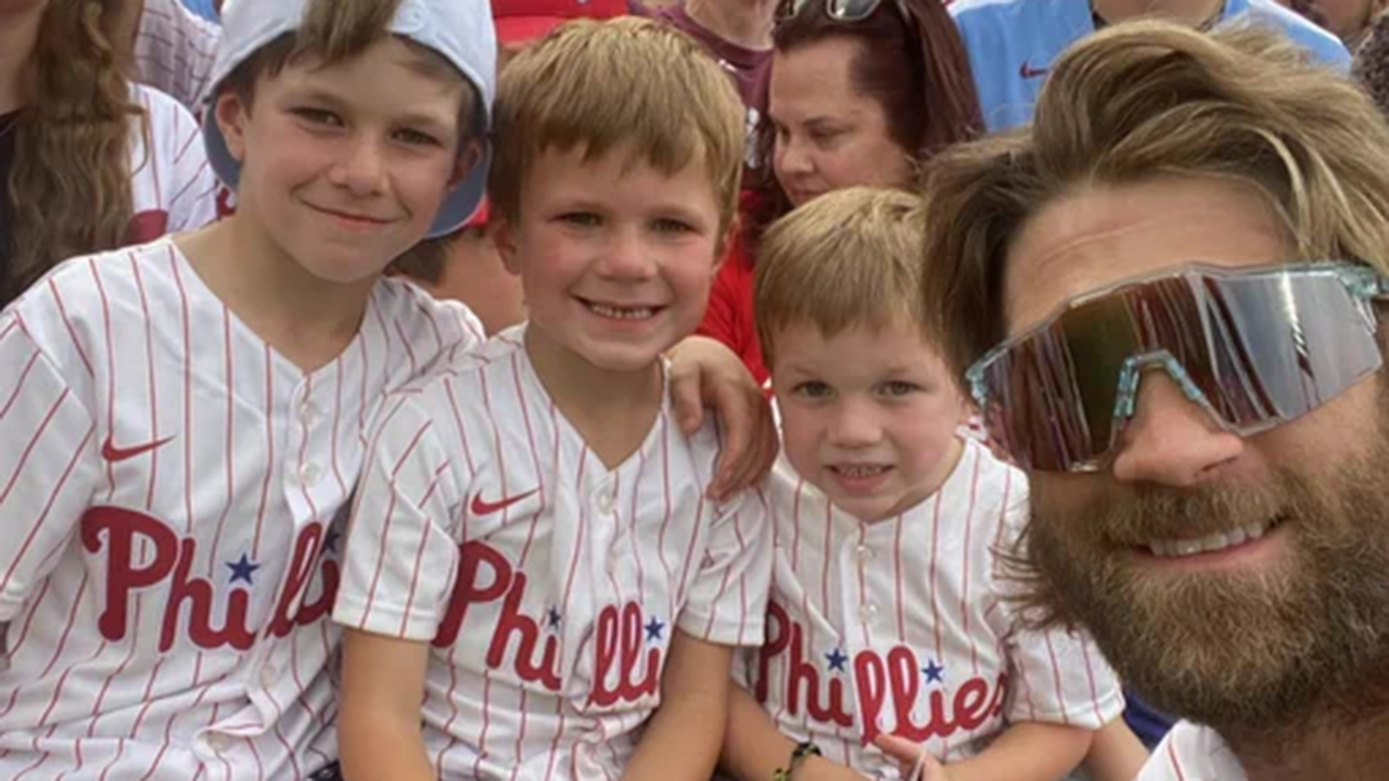 Bryce Harper poses for a photo with three young fans