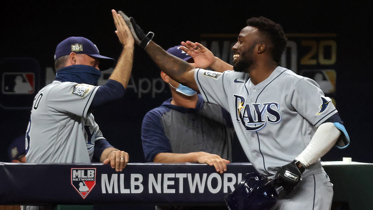 Randy Arozarena high-fives another player after hitting a home run