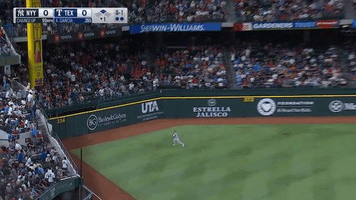 An animated gif of Jake Bauers making a sliding catch into the outfield wall