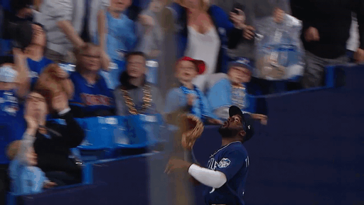 An animated gif of Taylor Trammell making a leaping catch near the stands