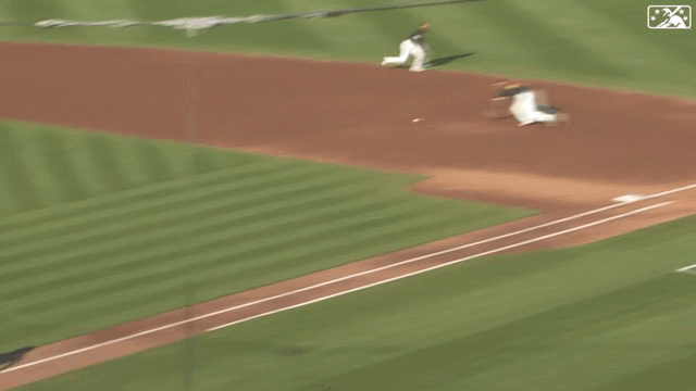 An animated gif of second baseman Darren Baker making a sliding, behind-the-back grab