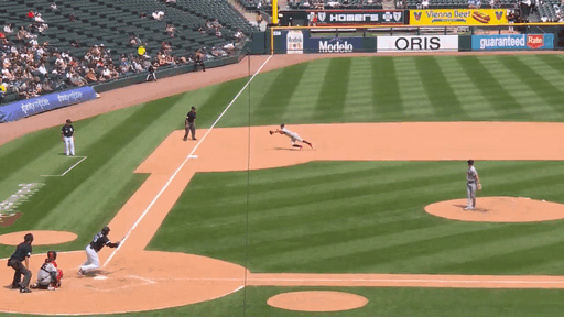 An animated gif of a third baseman making a diving play