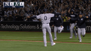 An animated gif of the Yankees running out to celebrate with Domingo Germán