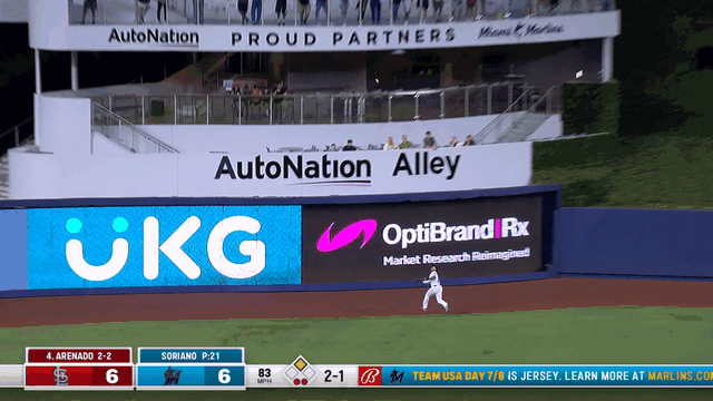 An animated gif of an outfielder running into a wall after making a catch