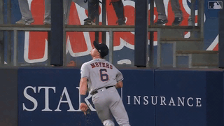 An animated gif of Jake Meyers making a sliding catch at the wall