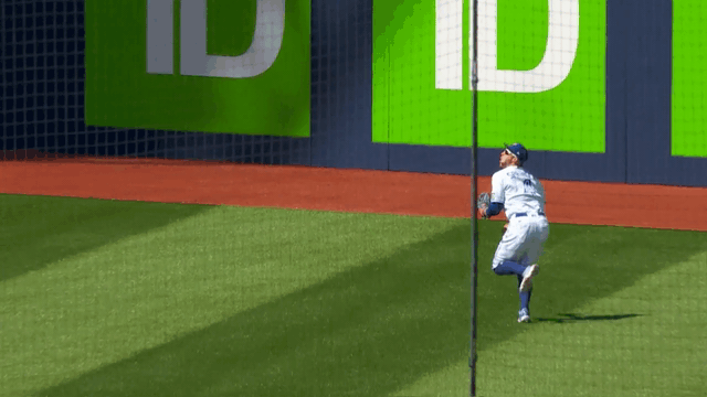 An animated gif of George Springer making a lunging catch