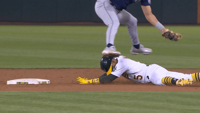 An animated gif of Josh Rojas tagging a sliding runner while leaping over him