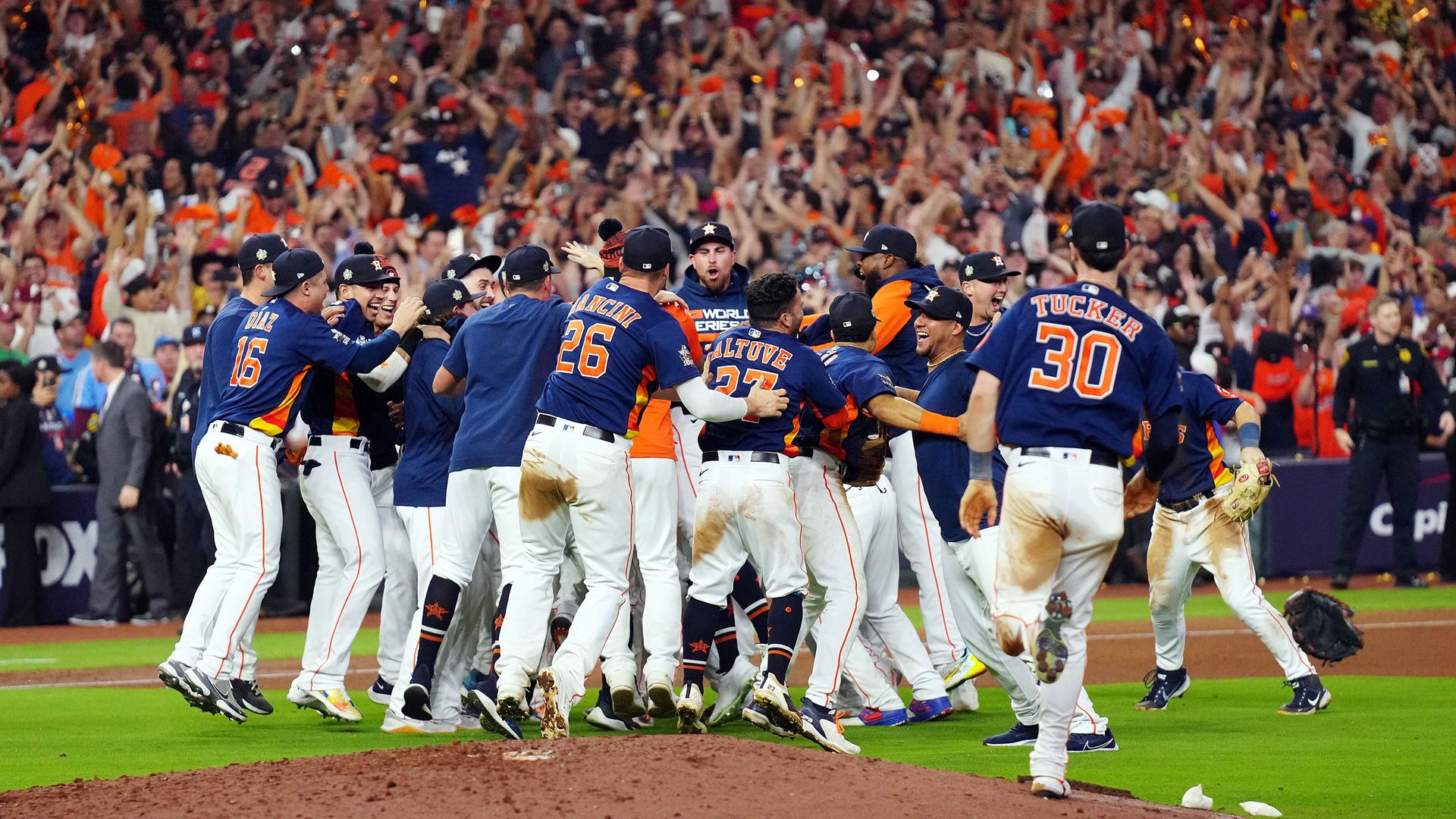 Astros players celebrate near the pitcher's mound