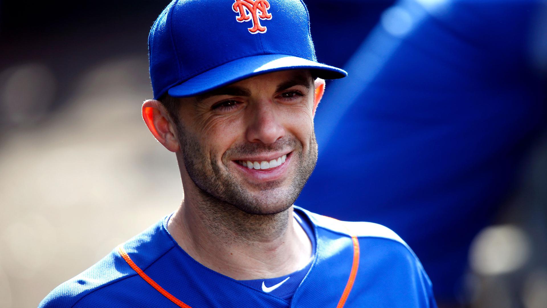 David Wright smiles in a blue Mets cap and jersey