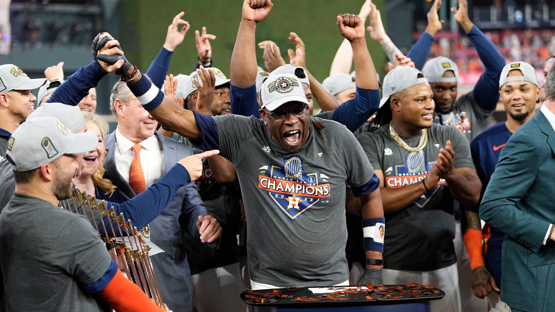 Dusty Baker celebrates on the podium with the team after the game