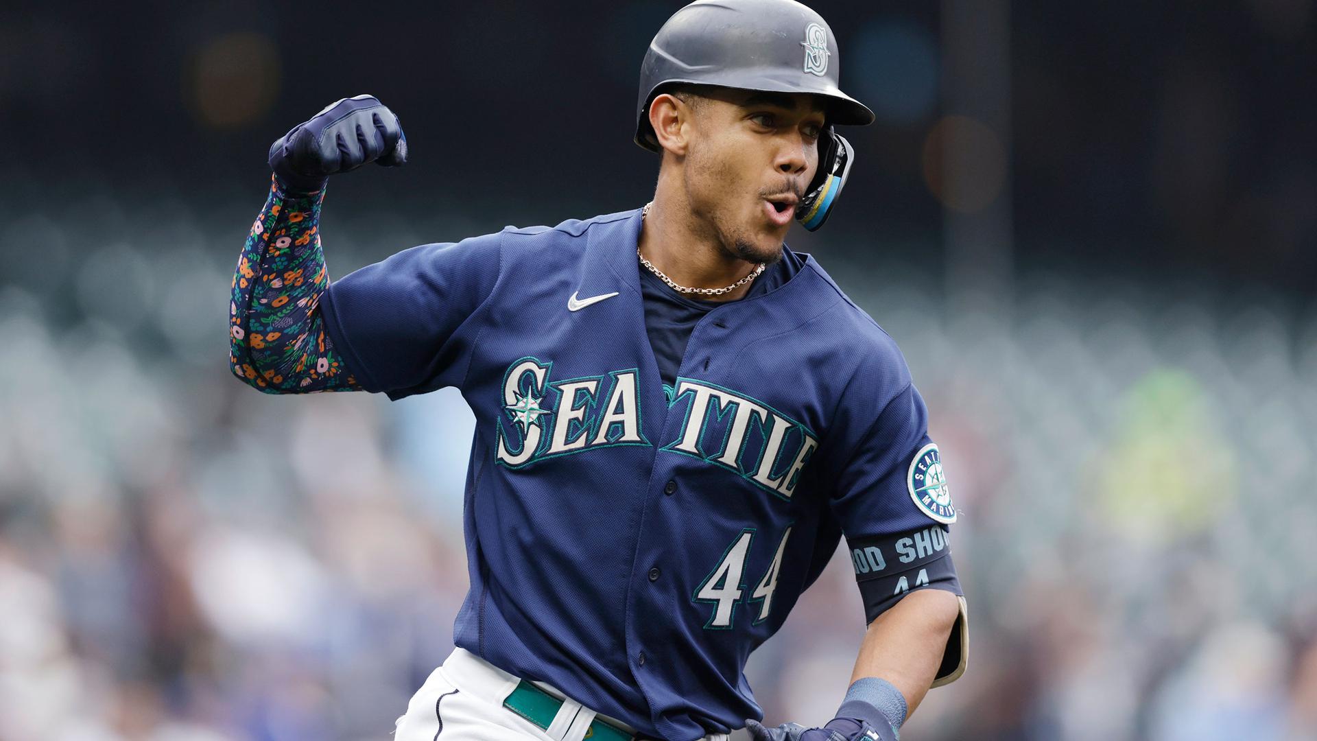 Julio Rodriguez pumps his arms as he rounds the bases