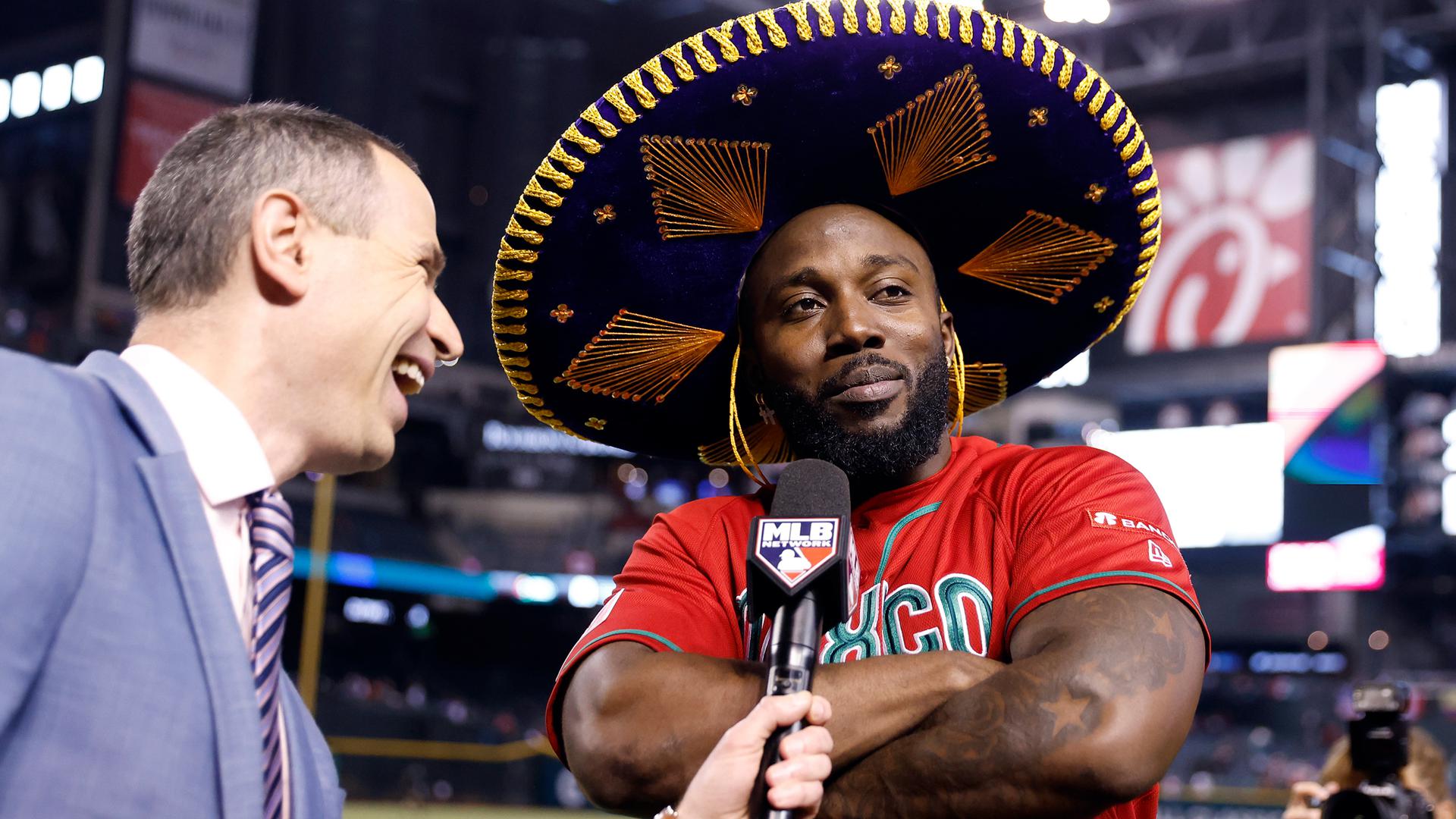 Randy Arozarena folds his arms while wearing a sombrero and being interviewed on TV