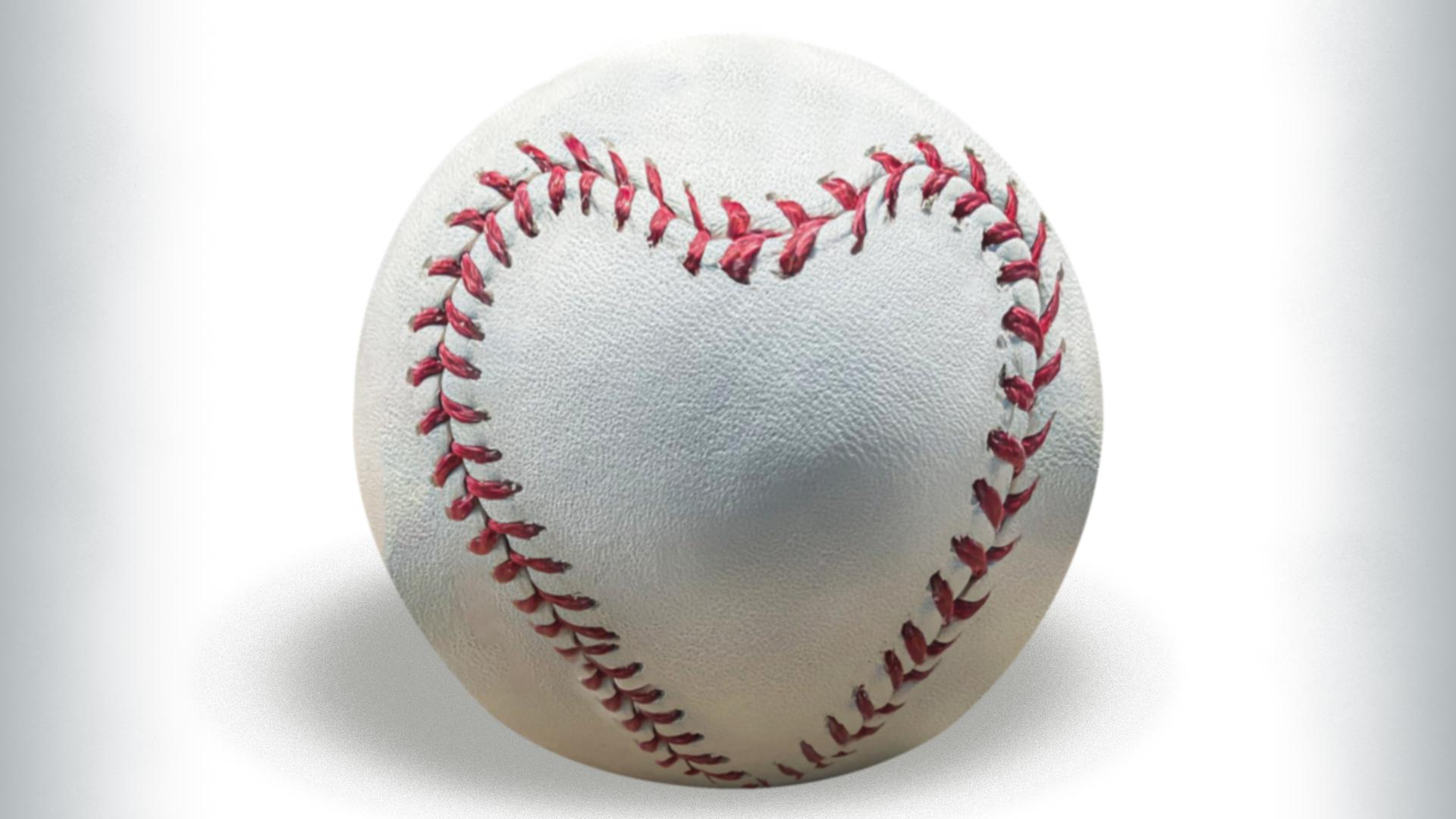 A photo illustration of a baseball with the stitches in the shape of a heart