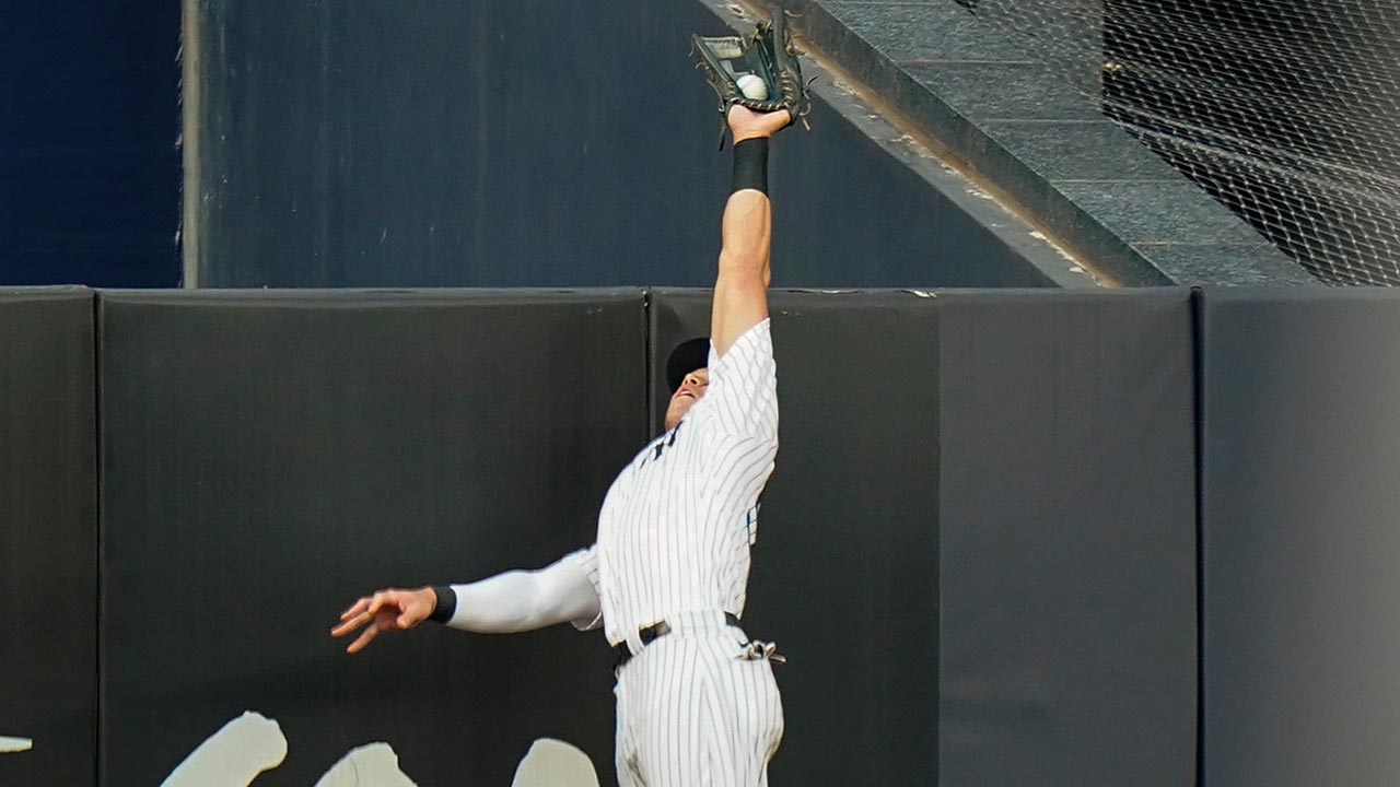 Aaron Judge leaps at the fence to take away a home run