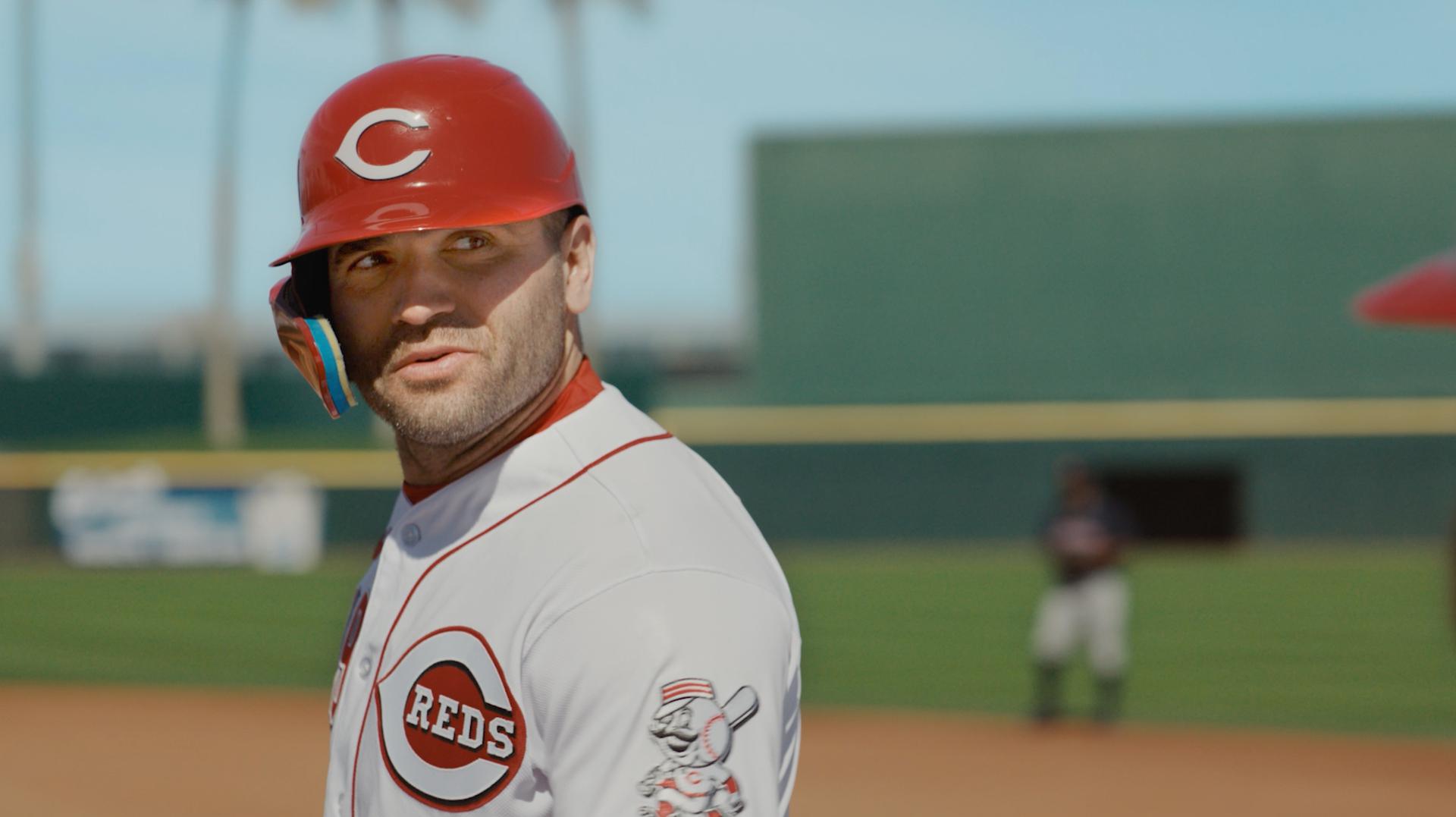 A screenshot of Joey Votto in a batting helmet at first base