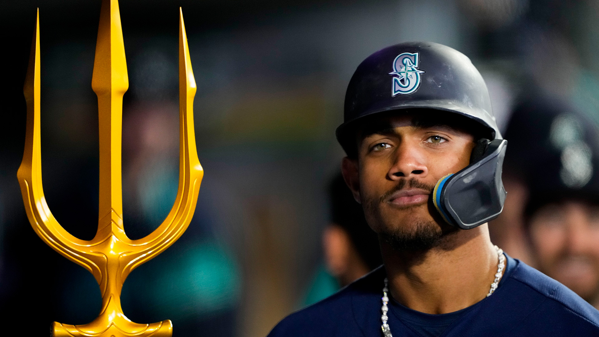 Julio Rodríguez in the dugout with a gold trident