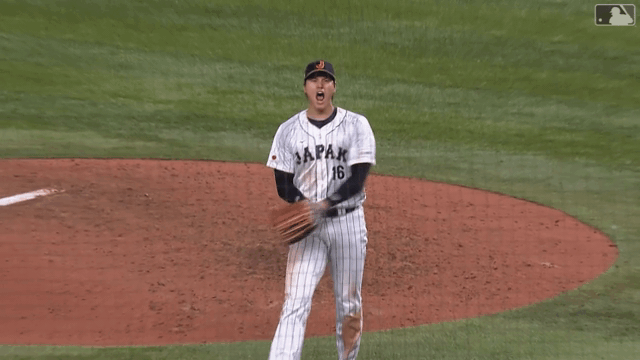 An animated gif of Shohei Ohtani throwing his glove and cap in celebration