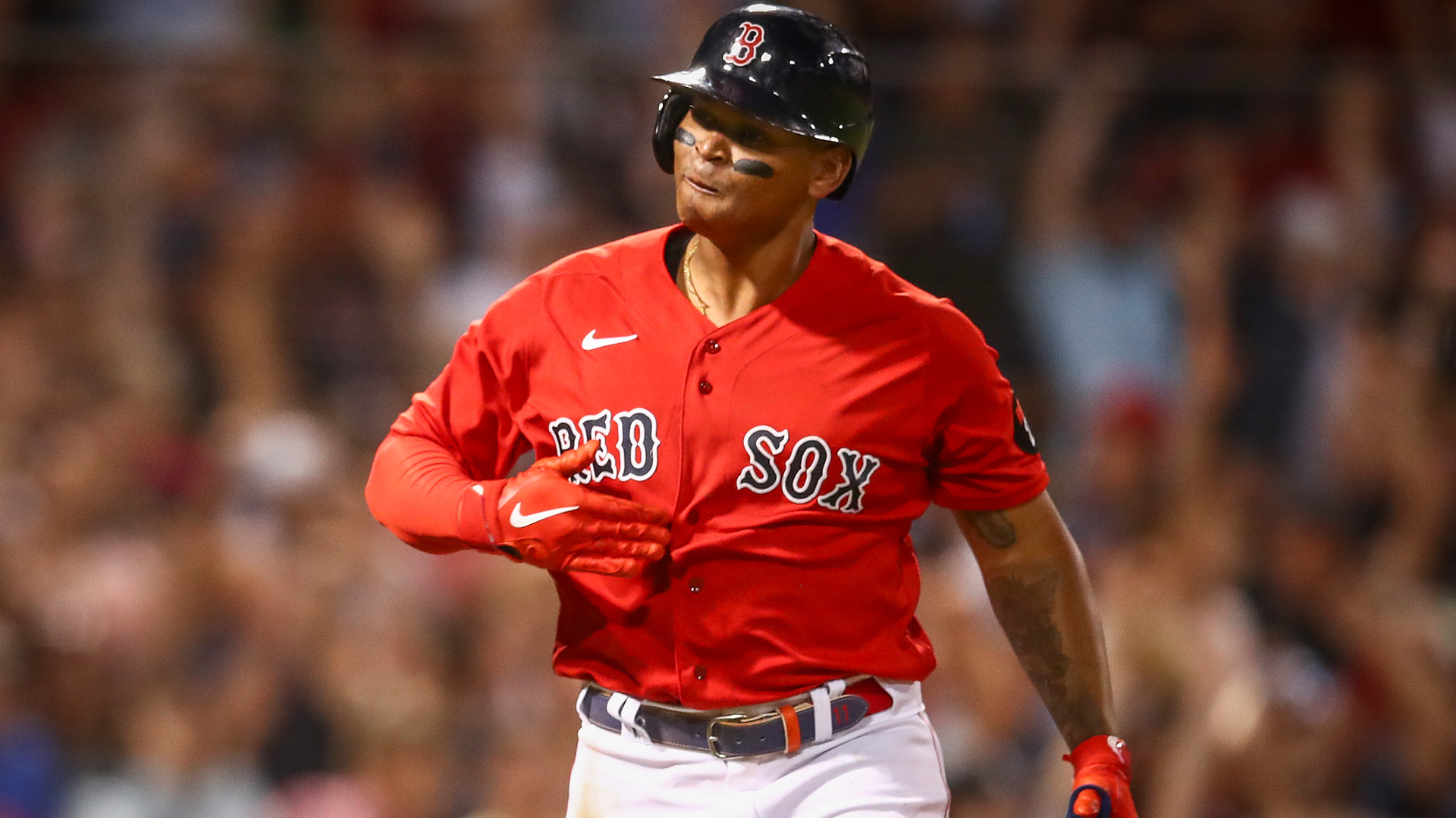 Boston's Rafael Devers slaps his chest after a big hit