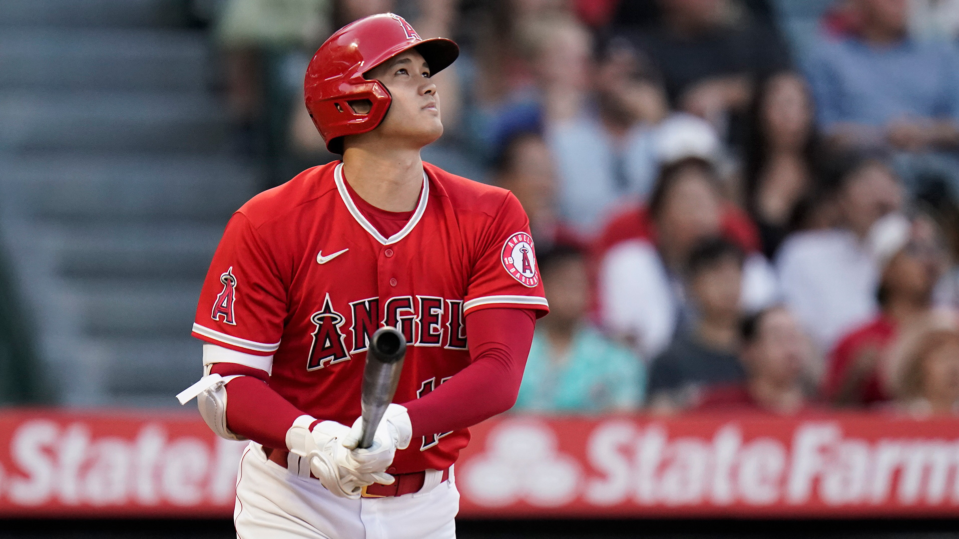 Shohei Ohtani watches a home run just before dropping his bat