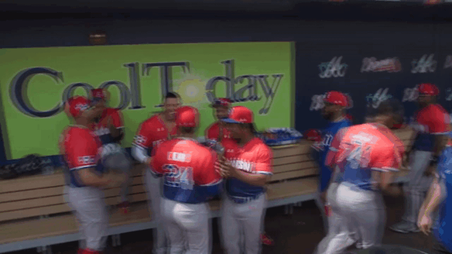 An animated gif of Dominican Republic players dancing in the dugout