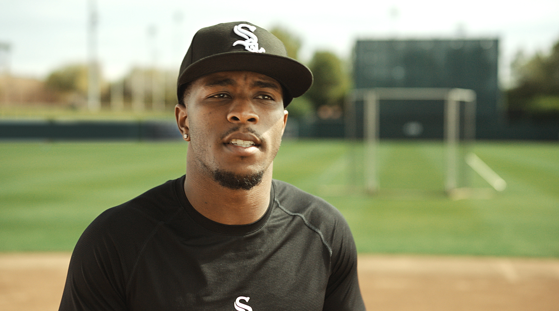 A close-up shot of Tim Anderson in the field in a black cap and black shirt