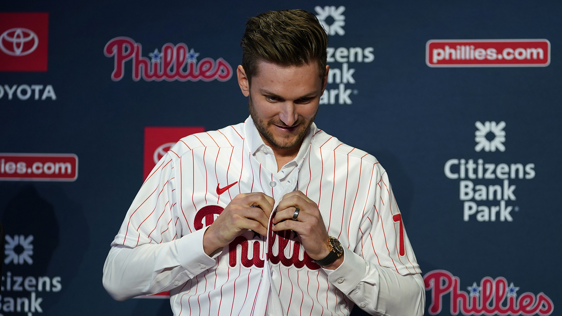 Trea Turner buttons up a Phillies jersey