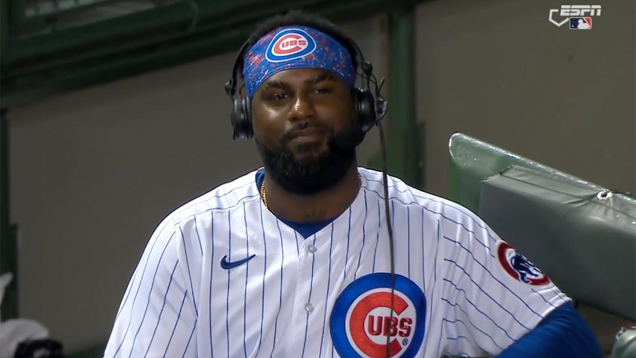 Franmil Reyes wears a microphone in the Cubs dugout