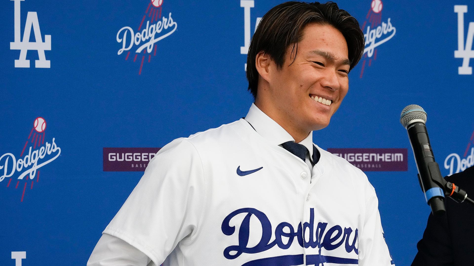 Yoshinobu Yamamoto smiles at his introductory news conference in Los Angeles